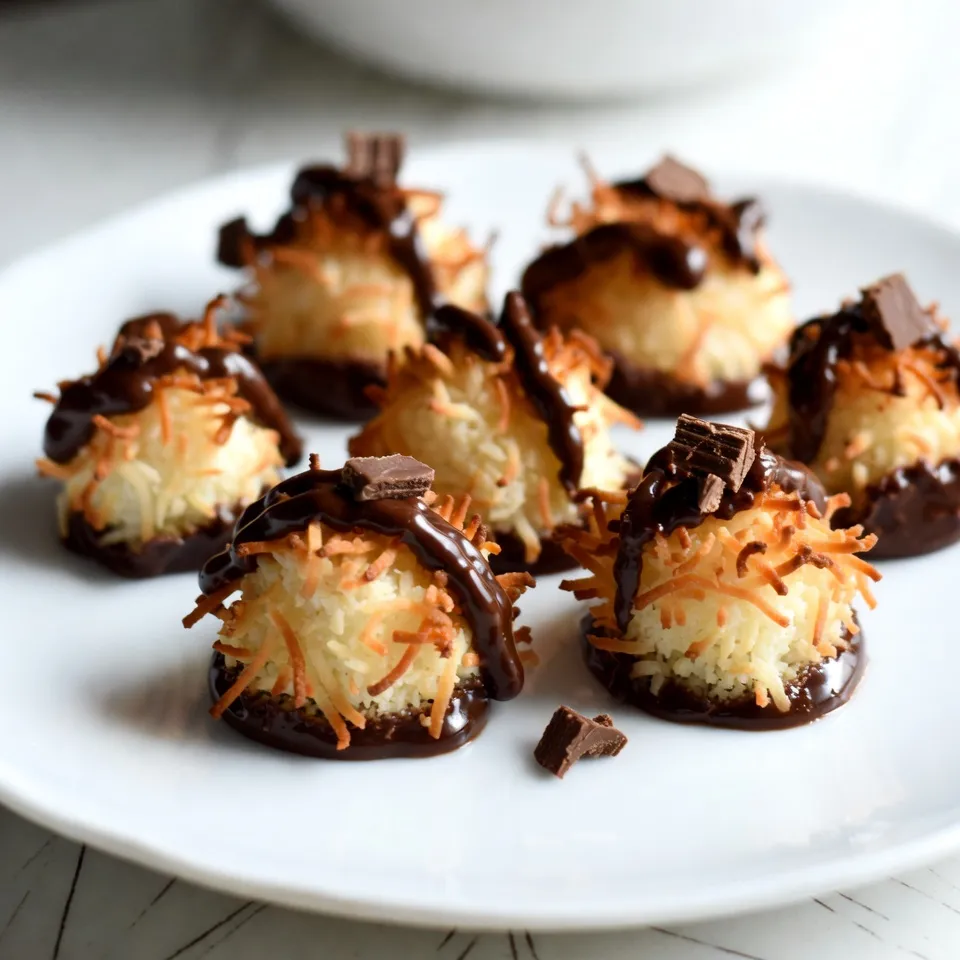 To make chocolate dipped coconut macaroons, gather these ingredients: - 2 ½ cups unsweetened shredded coconut - 1 cup sweetened condensed milk - 1 teaspoon vanilla extract - ¼ teaspoon salt - 2 large egg whites - 1 cup semi-sweet chocolate chips - 2 teaspoons coconut oil - Additional optional ingredients for variations These ingredients give the macaroons their sweet and chewy base. The coconut is the star here, providing a rich flavor and texture. Sweetened condensed milk binds everything together and adds a creamy touch. Vanilla and salt enhance the taste, balancing the sweetness. The egg whites help the macaroons rise and stay fluffy. For the chocolate dip, semi-sweet chocolate chips melt beautifully, creating a rich coating. Coconut oil makes the chocolate smooth and shiny. You can add other flavors or toppings, like almond extract or crushed nuts, to customize your macaroons. {{ingredient_image_2}} - Preheat your oven to 325°F (160°C). - Line a baking sheet with parchment paper. This helps with easy cleanup. - In a large bowl, combine 2 ½ cups of shredded coconut, 1 cup of sweetened condensed milk, 1 teaspoon of vanilla extract, and ¼ teaspoon of salt. - Stir the mixture well until the coconut is fully coated. This makes sure every bite is sweet and tasty. - In another bowl, use an electric mixer to whip 2 large egg whites. Beat them until soft peaks form. This step takes about 3-5 minutes. - Gently fold the whipped egg whites into the coconut mixture. Use a spatula to keep the airiness intact. - Use a tablespoon or cookie scoop to shape the macaroons. Place them on the prepared baking sheet. Leave space between each mound. - Bake for 20-25 minutes until the edges turn golden brown. The centers should feel set. - In a microwave-safe bowl, combine 1 cup of semi-sweet chocolate chips and 2 teaspoons of coconut oil. - Melt this mix in the microwave in 30-second intervals. Stir after each interval until smooth and glossy. - Once the macaroons are cool, dip the bottom of each one into the melted chocolate. Let excess chocolate drip back into the bowl. - Place the dipped macaroons back on the parchment paper. If you have extra chocolate, drizzle it over the tops for added flair. - Allow the chocolate to set completely. You can let them sit at room temperature or chill them in the fridge for about 30 minutes. To get the right texture, you need the right balance. Use unsweetened coconut for a chewy bite. Sweetened condensed milk adds sweetness but can make them too soft if you use too much. Aim for a sticky mixture that holds together well. Avoid overmixing when you fold in the egg whites. You want to keep the air in the mix. This helps the macaroons rise and stay light. Gently fold until everything is just combined. If you mix too hard, your macaroons will be dense and flat. For melting chocolate, the microwave is a quick option. Use a microwave-safe bowl and heat in 30-second bursts. Stir after each interval. This helps prevent burning. You want the chocolate to be smooth and glossy. Adding coconut oil to the chocolate helps keep it shiny. It also makes the chocolate easier to dip. If your chocolate cools too much, it can clump. Just reheat it gently in the microwave. Presentation can make a big difference. Arrange the macaroons on a nice plate. For a pop of color, add a sprig of mint. You can sprinkle some chocolate shavings on the side too. This adds elegance and makes them look fancy. Pair these macaroons with drinks like coffee or tea. They also taste great with milk or a scoop of ice cream. The sweet coconut and rich chocolate will delight your taste buds! Pro Tips Use Fresh Coconut: For a more vibrant flavor, consider using fresh coconut instead of shredded coconut. You’ll need to dry it slightly before mixing. Perfect Egg Whites: Ensure your mixing bowl and beaters are completely clean and dry before whipping the egg whites to achieve maximum volume. Chocolate Melting Tips: Stir the chocolate regularly while melting to prevent it from burning and to ensure a smooth consistency. Storage Advice: Store leftover macaroons in an airtight container at room temperature for up to a week, or refrigerate for longer freshness. {{image_4}} You can easily change the taste of your macaroons. Adding almond extract gives a sweet nutty flavor. Just one teaspoon will do. You can also infuse flavors like orange or lemon. Adding zest from these fruits will brighten the taste. If you want to switch up the chocolate, use dark chocolate or white chocolate. Dark chocolate has a rich flavor, while white chocolate is sweet and creamy. You can also add toppings. Try crushed nuts for crunch or sea salt for a savory touch. Making gluten-free macaroons is simple. All the ingredients are naturally gluten-free. For vegan options, replace the egg whites. Use aquafaba, the liquid from chickpeas. It whips up just like egg whites. You can still enjoy these tasty treats no matter your diet! Store your macaroons in an airtight container. This keeps them fresh and moist. You can use glass jars or plastic containers. Make sure to place parchment paper between layers to avoid sticking. At room temperature, they last about 3 to 5 days. If you want to keep them longer, refrigeration is best. In the fridge, they can last up to 2 weeks. To freeze macaroons, first let them cool completely. Once cool, place them on a baking sheet in a single layer. Freeze for about 1 hour until firm. Then, transfer them to a freezer-safe bag or container. This method prevents them from sticking together. When ready to eat, take out the number you want. Thaw them at room temperature for about 30 minutes. For best results, avoid using the microwave to thaw. This keeps the texture just right. Chocolate dipped coconut macaroons are sweet treats made from coconut, egg whites, and chocolate. They have a crunchy outside and a chewy inside. The chocolate dip adds a rich flavor that makes them even better. These macaroons are perfect for dessert or a snack. Chocolate macaroons can last about one week at room temperature. Store them in an airtight container to keep them fresh. If you chill them, they can last up to two weeks. Just remember, they taste best when fresh! Yes, you can make chocolate macaroons ahead of time. Just bake them and let them cool completely. Then, dip them in chocolate before serving. You can store them in the fridge for up to a week. This way, you have a tasty treat ready to enjoy! If you need a substitute for sweetened condensed milk, try coconut cream or homemade alternatives. Mix one cup of milk with a half cup of sugar, then simmer until thick. This can work well in macaroons. Adjust the sugar based on your taste. Yes, chocolate dipped coconut macaroons are gluten-free! They are made with coconut and egg whites, which do not contain gluten. Check the chocolate chips to ensure they are also gluten-free. This makes them a great option for those with gluten sensitivities. Yes, you can use shredded coconut instead of flaked coconut. Shredded coconut will change the texture slightly. It can make the macaroons a bit denser, but they will still taste great. Just ensure it is unsweetened for the best results! Making chocolate dipped coconut macaroons is simple and fun. You start with fresh ingredients, mix them well, and shape the macaroons. After baking, a dip in chocolate adds a sweet touch. With tips for perfect texture and a range of variations, you can truly make this treat your own. Remember to store them right for the best taste. Enjoy these delightful bites at any time, and feel free to share them with friends. Now, it's your turn to create these tasty treats in your own kitchen!
