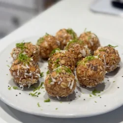 - Rolled oats: These oats provide a hearty base. They are full of fiber and help keep you full. - Shredded coconut: This adds a tropical flair. It gives flavor and texture to each bite. - Nut butter options: Almond butter is my go-to, but you can use peanut butter. Both add creaminess and healthy fats. - Sweetener options: I use honey or maple syrup. These natural sweeteners bring a nice balance to the tart lime. - Chocolate chips: Mini dark chocolate chips add a sweet twist. They pair well with the lime flavor. - Seed options: Chia seeds boost nutrition. They are rich in omega-3 and add a nice crunch. - Additional flavorings: Consider adding vanilla or crushed nuts. These can enhance the taste and texture. {{ingredient_image_2}} To start, gather all your ingredients. This step makes cooking easier and faster. In a medium bowl, mix together the dry ingredients. Add: - 1 cup rolled oats - 1/2 cup unsweetened shredded coconut - 1 tablespoon chia seeds - 1/4 teaspoon sea salt Stir these ingredients until they blend well. This blend gives your energy bites a nice texture and taste. Next, take another bowl and whisk the wet ingredients. Combine: - 1/3 cup almond butter (or peanut butter) - 1/4 cup honey or maple syrup - Zest of 1 lime - 2 tablespoons freshly squeezed lime juice Mix until it is smooth and well combined. This mixture brings out that zesty flavor. Now, it's time to merge the wet and dry mixtures. Pour the wet mixture into the bowl with the dry ingredients. Use a spatula or wooden spoon to mix everything thoroughly. You want every bit to be coated and combined. If you like chocolate, this is the time to add 1/4 cup mini dark chocolate chips. Gently fold them in. This adds a sweet surprise to your bites. Now, let's shape the energy bites. With clean hands, scoop out portions of the mixture. Roll them into small balls, about 1 inch in diameter. If the mix is sticky, wet your hands with a little water to help. Once you have rolled out all the bites, place them on a tray lined with parchment paper. This makes cleanup easier. To help them firm up, chill the tray in the refrigerator for at least 30 minutes. After chilling, transfer your energy bites to an airtight container. They stay fresh in the fridge for up to a week or can be frozen for longer storage. Enjoy your refreshing coconut lime energy bites! If you want to use a different nut butter, go for peanut butter. It gives a nice taste. Sunflower seed butter is another good choice for nut-free diets. For sweeteners, honey works great, but maple syrup is a nice vegan option. Both options add a rich flavor. To adjust the sweetness, taste the mix before you roll it into bites. If you want it sweeter, add a bit more honey or maple syrup. To enhance the lime flavor, add extra lime juice or zest. This makes the bites zesty and fresh. For presentation, serve your energy bites on a colorful platter. You can sprinkle extra lime zest and shredded coconut on top for a fun look. Pair these bites with a cold drink, like coconut water or iced tea. This combo makes a refreshing snack! Pro Tips Chill for Firmness: Allow the energy bites to chill for at least 30 minutes in the refrigerator to help them set and hold their shape better. Flavor Variations: Experiment with different nut butters or add-ins like dried fruit, seeds, or spices to customize the flavor of your energy bites. Storage Tips: Store energy bites in an airtight container in the refrigerator for up to a week, or freeze them for longer shelf life. Mess-Free Rolling: If the mixture is too sticky, wet your hands slightly with water to make rolling the bites easier and less messy. {{image_4}} You can change the taste of these energy bites easily. Try adding tropical fruits like mango or pineapple. These fruits mix well with coconut and lime. They give a sweet and sunny flavor. You can also add dark chocolate chips. They add a rich taste that pairs nicely with lime. Just fold in the chocolate chips when mixing. If you want a vegan option, use maple syrup instead of honey. Almond butter is already vegan-friendly. For gluten-free bites, make sure your oats are certified gluten-free. This way, you can enjoy these treats without worry. You can change the texture of your bites, too. If you like a crunchy snack, add chopped nuts. If you want chewy bites, stick to the original recipe. You can also make larger or smaller bites. Just adjust the size when rolling them. Smaller bites are great for snacking, while larger ones can fill you up more. To keep your Coconut Lime Energy Bites fresh, store them in an airtight container. If you place them in the fridge, they will stay tasty. Make sure to keep them covered. This helps prevent them from drying out. For longer storage, you can freeze the energy bites. Just place them in a freezer-safe bag or container. Make sure to remove as much air as possible. This will help keep them fresh and avoid freezer burn. In the fridge, these bites last up to a week. You can grab them for a quick snack or energy boost. They taste best fresh but are still good for several days. When you freeze them, Coconut Lime Energy Bites can last up to three months. This makes them perfect for meal prep. You can whip up a batch now and enjoy them later! To enjoy your frozen bites, let them thaw in the fridge. This keeps their texture nice. You can also leave them out on the counter for about 15 minutes. They will be ready to eat when soft but still firm. Avoid microwaving them, as it may change their taste and texture. To make these bites, follow these steps: 1. Mix Dry Ingredients: In a medium bowl, combine 1 cup of rolled oats, 1/2 cup of unsweetened shredded coconut, 1 tablespoon of chia seeds, and 1/4 teaspoon of sea salt. Stir until well mixed. 2. Whisk Wet Ingredients: In another bowl, whisk together 1/3 cup of almond butter, 1/4 cup of honey or maple syrup, 2 tablespoons of fresh lime juice, and the zest of 1 lime. Mix until smooth. 3. Combine Mixtures: Pour the wet mixture into the dry ingredients. Stir with a spatula until fully combined. If you want chocolate, fold in 1/4 cup of mini dark chocolate chips. 4. Form Bites: Use clean hands to scoop out portions and roll them into small balls, about 1 inch wide. If they are sticky, wet your hands slightly. 5. Chill: Place the bites on a tray lined with parchment paper. Refrigerate for at least 30 minutes to firm them up. 6. Store: Transfer to an airtight container. These bites can last up to a week in the fridge or be frozen for longer storage. Coconut and lime bring great health benefits: - Coconut: It is rich in healthy fats, fiber, and minerals like manganese and copper. These nutrients support heart health and digestion. - Lime: Limes are full of vitamin C, which helps boost the immune system. They also contain antioxidants that fight free radicals. Together, they create a refreshing snack that fuels your body and tastes great. Yes, you can use different nut butters: - Peanut Butter: This is a common substitute and adds a rich flavor. - Cashew Butter: This option provides a creamy texture and a sweet taste. - Sunflower Seed Butter: Great for nut allergies, it has a unique flavor. Feel free to experiment and find your favorite! These energy bites have a good shelf life: - Refrigerator: Store them in an airtight container for up to a week. - Freezer: They can last for about three months in the freezer. Just thaw them in the fridge before eating. This makes them a perfect grab-and-go snack! In this article, we explored how to make delicious Coconut Lime Energy Bites. We covered key ingredients, from oats to nut butter. Step-by-step instructions made it easy to follow the process. We shared helpful tips and variations to suit your taste. Lastly, we discussed storage methods to keep your bites fresh. I hope this guide inspires you to create your own tasty energy bites. Enjoy exploring flavors and sharing these snacks with others!